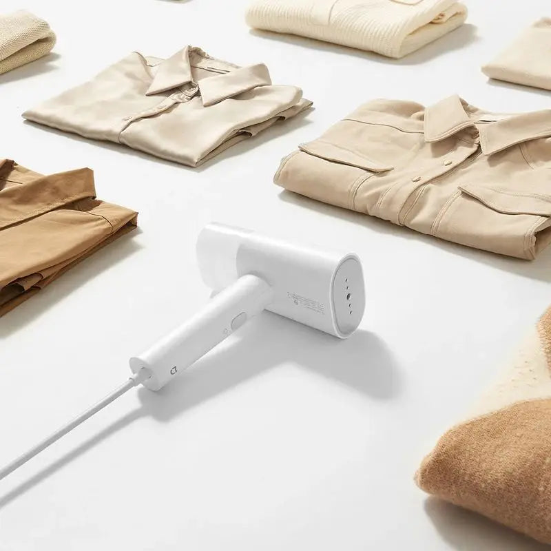 Tidesmit MIJIA portable foldable garment steamer 3 performing flat ironing and mite removal on fabric