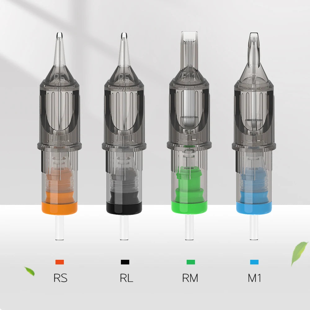 Four clear plastic tattoo needle cartridges with orange, black, green, and blue internal color-coded bases.