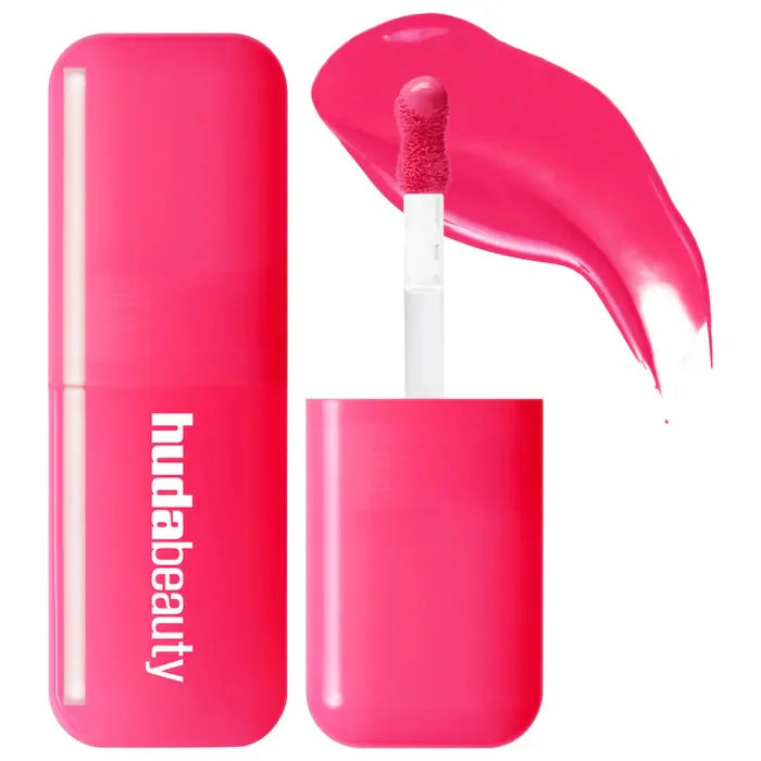 Huda Beauty hydrating lip and cheek tint in vibrant hot pink with creamy texture and doe-foot applicator.