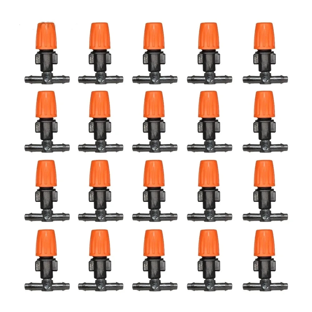Orange 8-hole drip emitters on black bases, multiple pieces