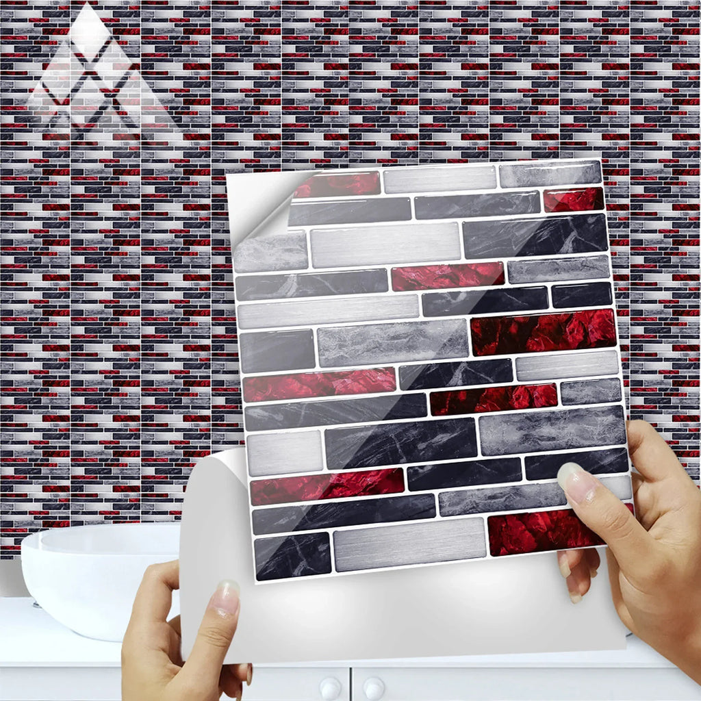 Self-adhesive 3D brick tile sticker being applied with hand on wall, gray and dark tiles