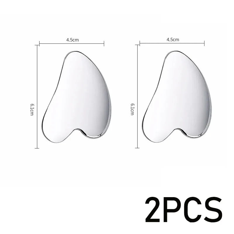 Two smooth, heart-shaped silver gua sha facial massage tools with measurement markings indicating 4.5cm by 6.1cm.