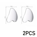 Two smooth, heart-shaped silver gua sha facial massage tools with measurement markings indicating 4.5cm by 6.1cm.
