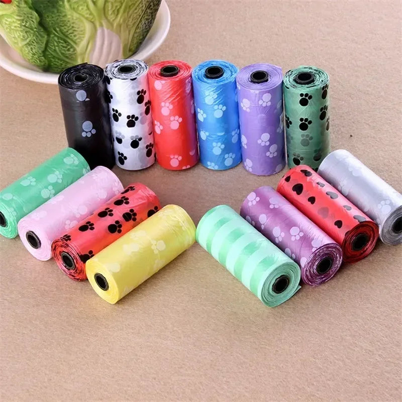 Colorful, leak-proof dog poop bags with cartoon paw prints in various rolls for convenient pet waste cleanup.