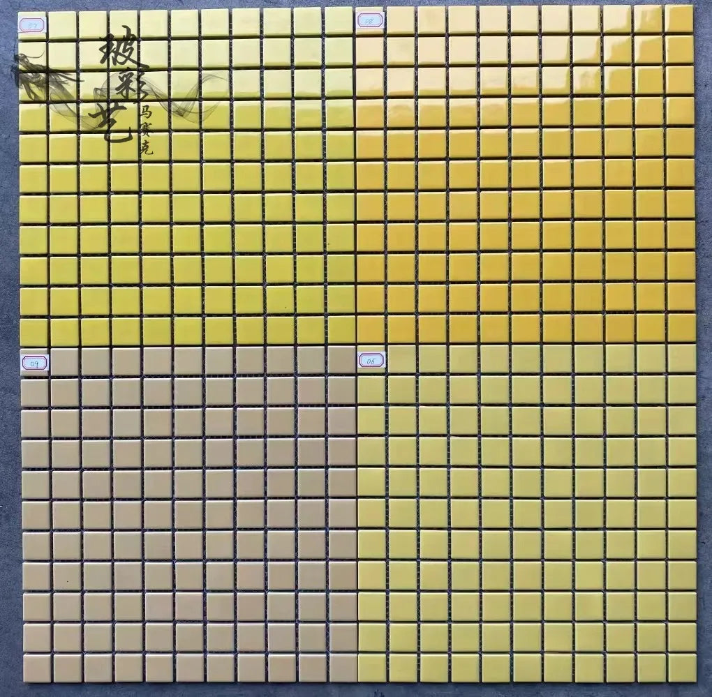 Ceramic mosaic tile sheet with yellow upper tiles and gray lower tiles on grid