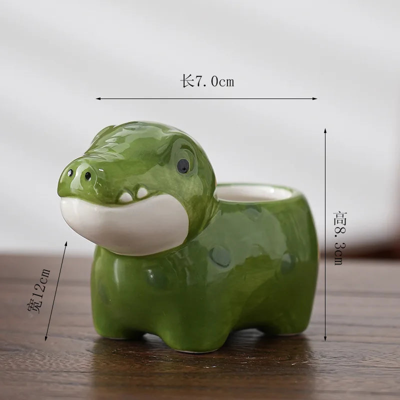 Green animal-shaped ceramic flower pot with white muzzle and raised bowl center