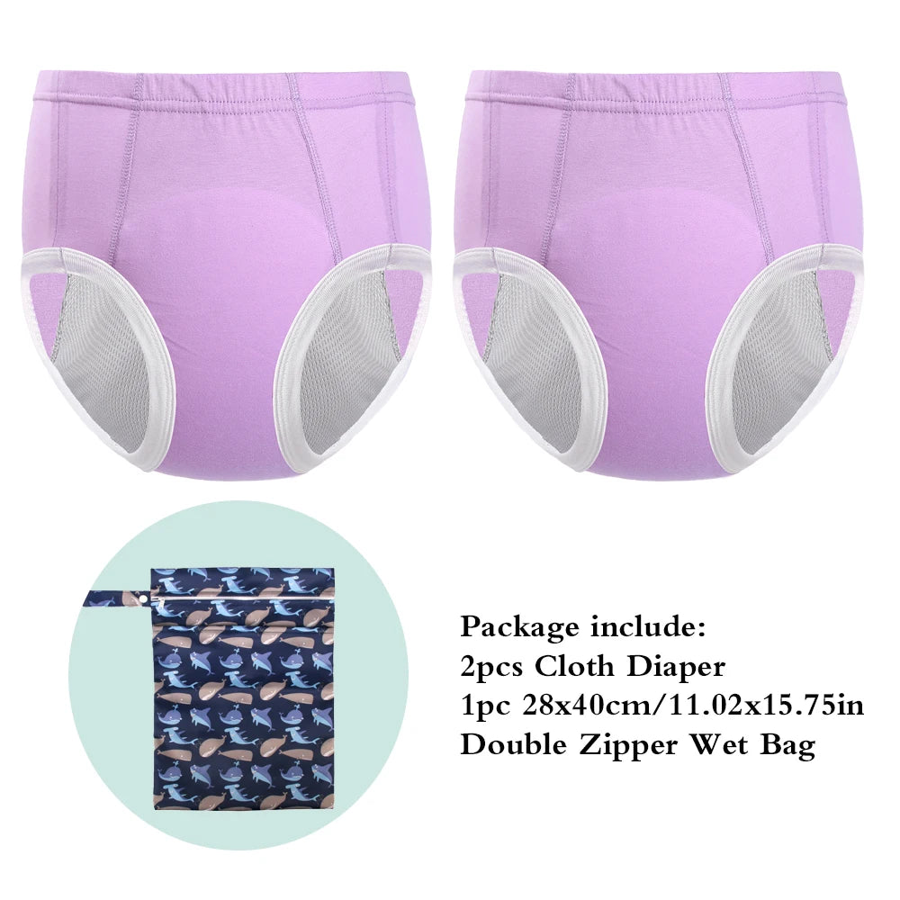 2 purple reusable baby cloth diapers and 1 whale print double zipper wet bag.