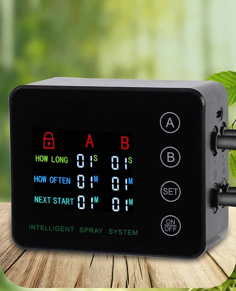Black mist spray system controller on a wooden surface with connected dual outlets