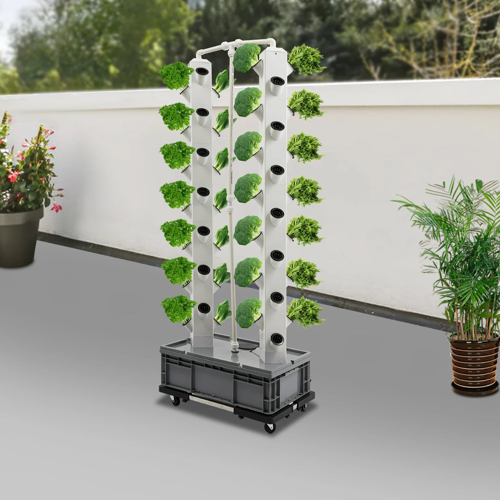 Hydroponic growing tower with white columns and planting holes, black wheeled base, leafy greens