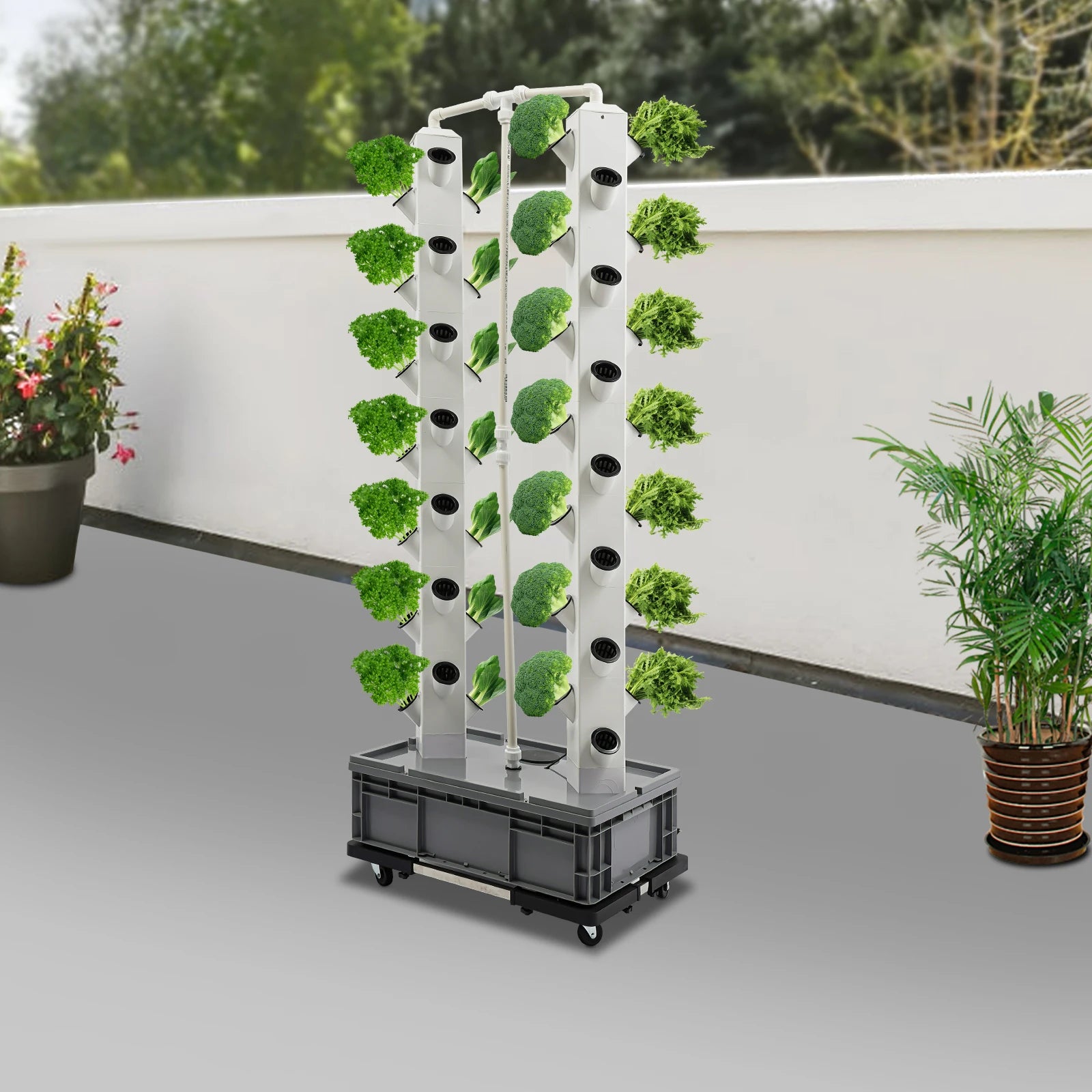 Hydroponic growing tower with white columns and planting holes, black wheeled base, leafy greens
