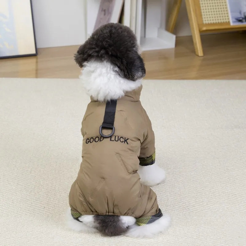 Small dog wearing a beige waterproof winter jumpsuit with harness attachment for warm, cozy outdoor walks.