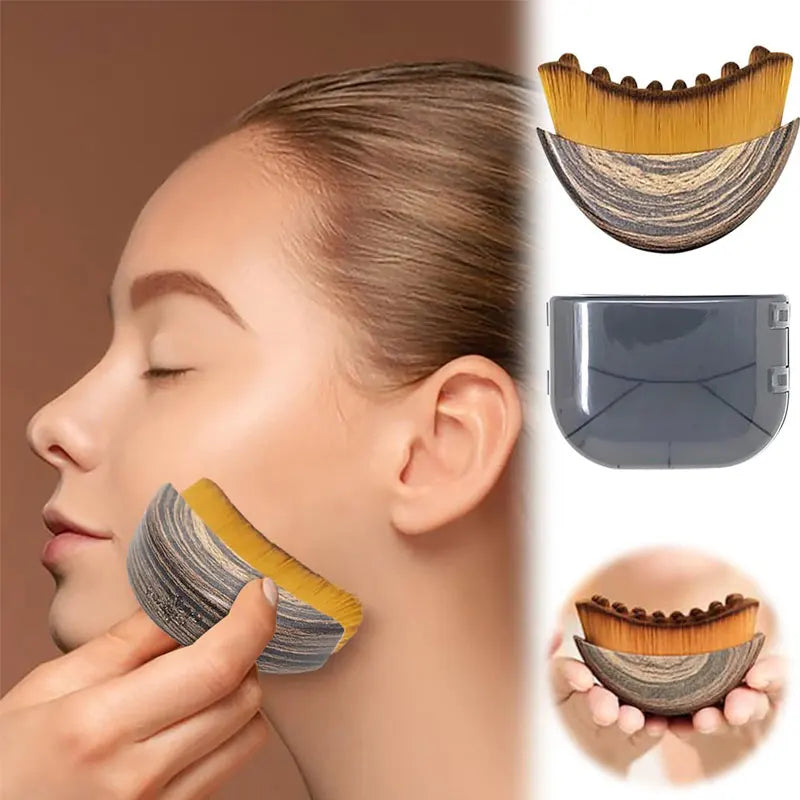 Curved face massage brush with wooden handle and gold bristles, shown in use on a jawline with a protective gray cover.