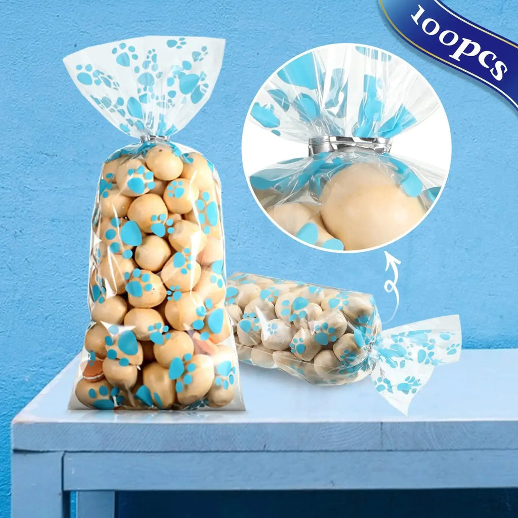 100pcs blue paw print cellophane bags for pet birthday party favor treats. Heat-sealable plastic bags for pet snacks.