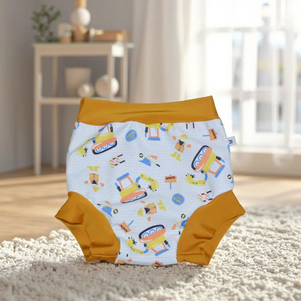 Size M baby diaper with mustard trim and fun construction vehicle print, perfect for comfortable baby care.