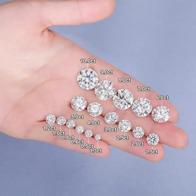 Hand holding loose round pink diamonds on a light background with carat labels