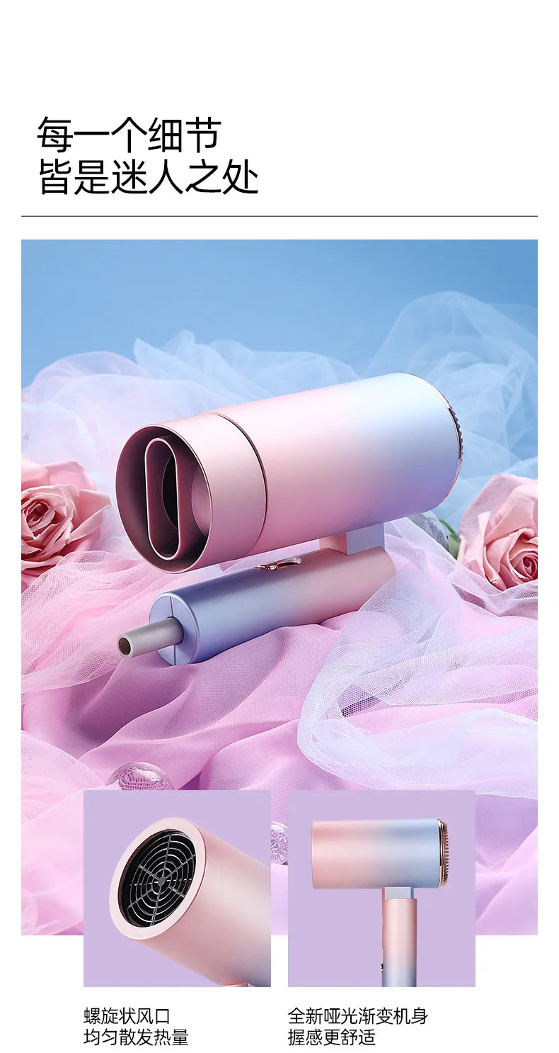 Foldable mini ionic hair dryer in matte pastel gradient pink and blue, featuring a professional nozzle attachment.