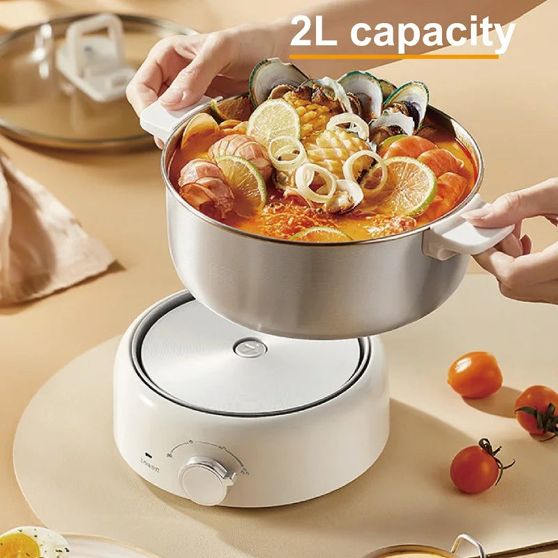 2L electric cooking pot with stainless inner pot, clear lid, and white base