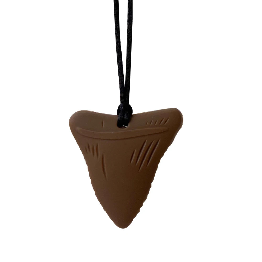 Brown shark tooth silicone teething toy for baby teething relief.