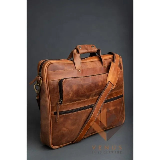 Tan genuine leather business briefcase with dual handles, crossbody strap, and front zip pockets. Designer handbag.