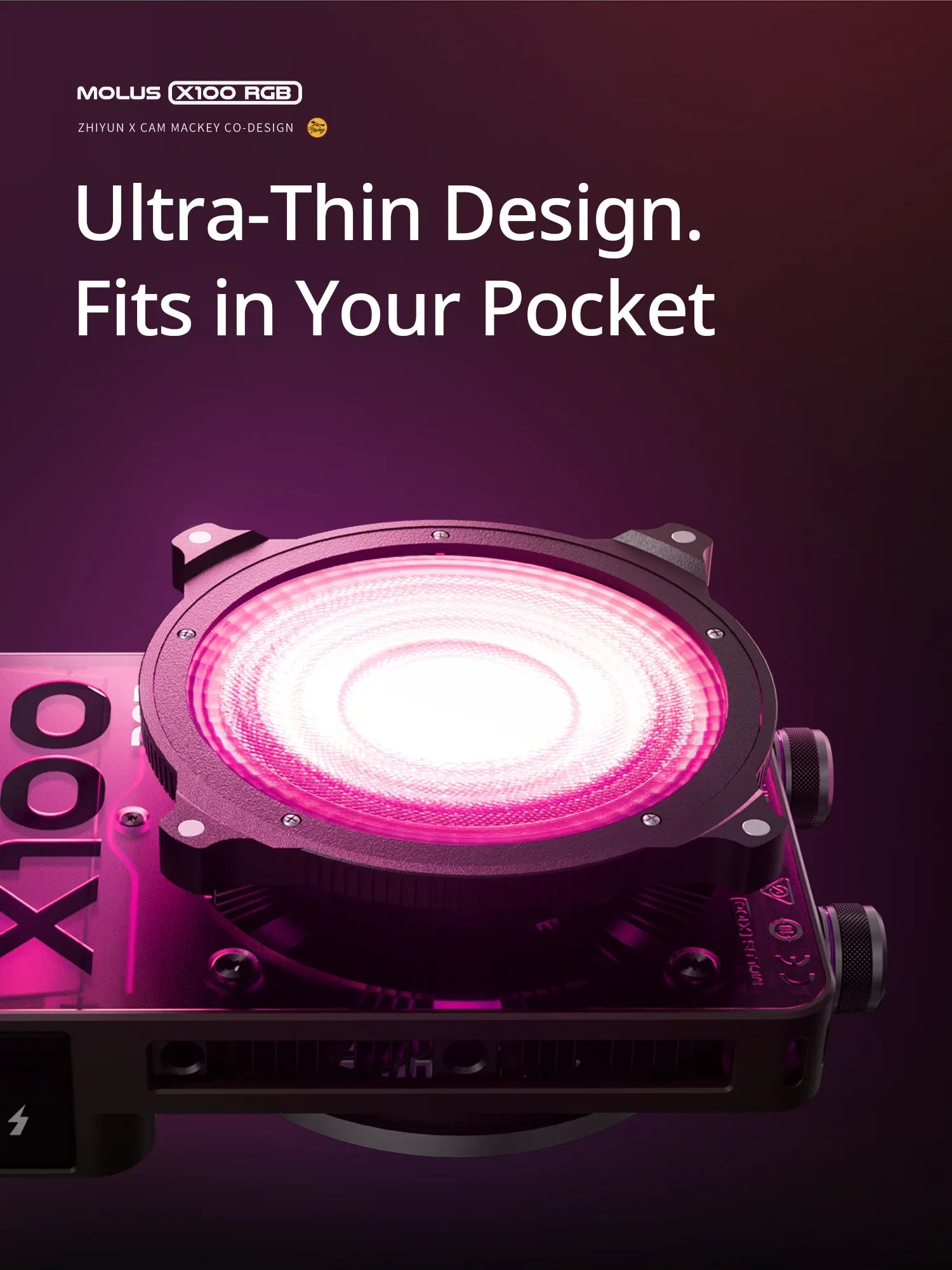 Molus X100 RGB compact LED video light with a circular black housing, emitting a bright pink glow for photography.