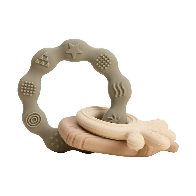 Olive and beige silicone baby teething ring set for soothing sore gums.
