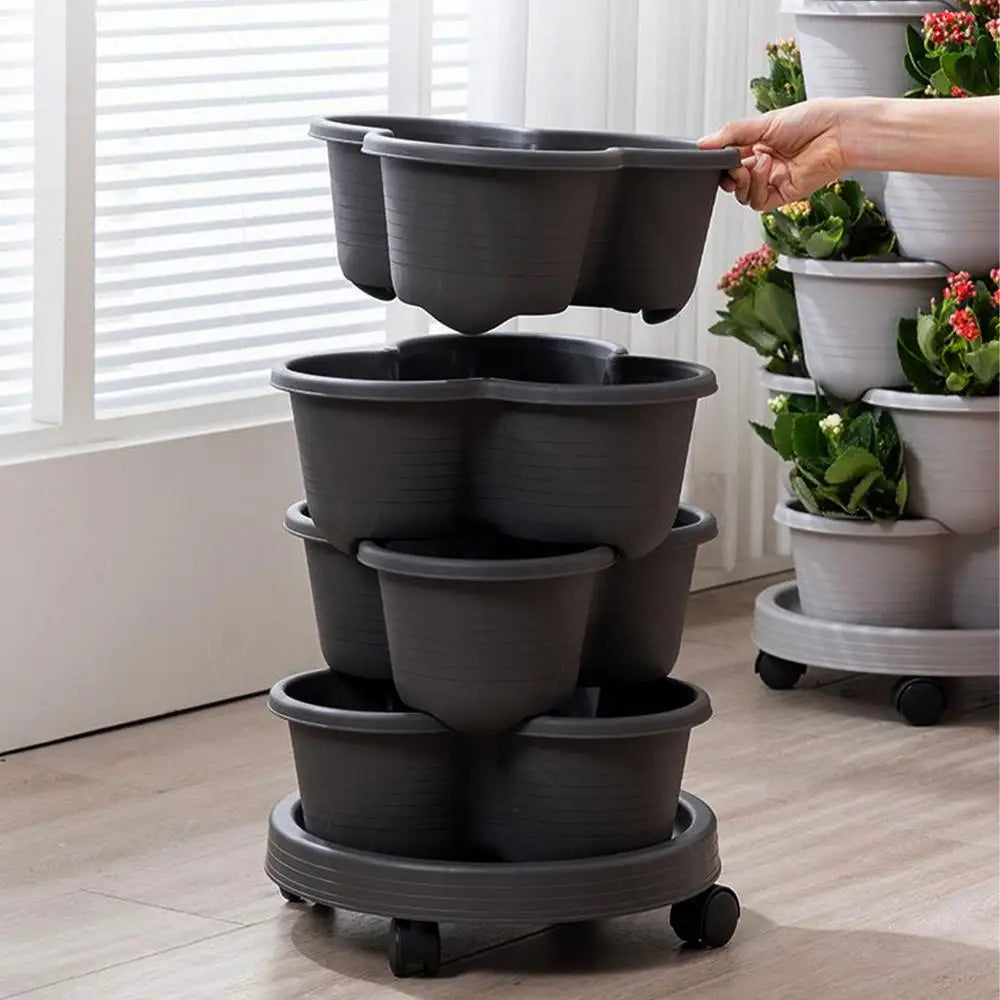 Hand placing dark gray nesting pots on a 3-tier vertical planter tower base