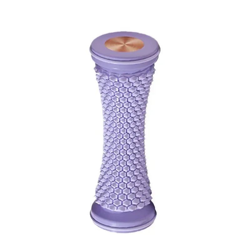 Purple manual foot massage roller with textured honeycomb surface for plantar fasciitis relief and muscle relaxation.