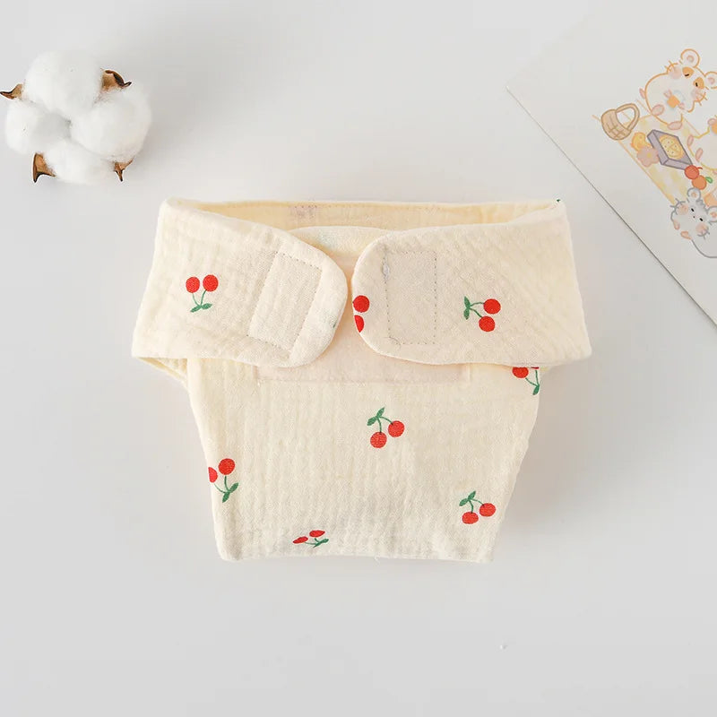 Reusable cloth baby diaper with cream fabric and red cherry print design.