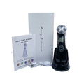 Black EMS facial massager on a charging base with a white box, user manual, and charging cable.