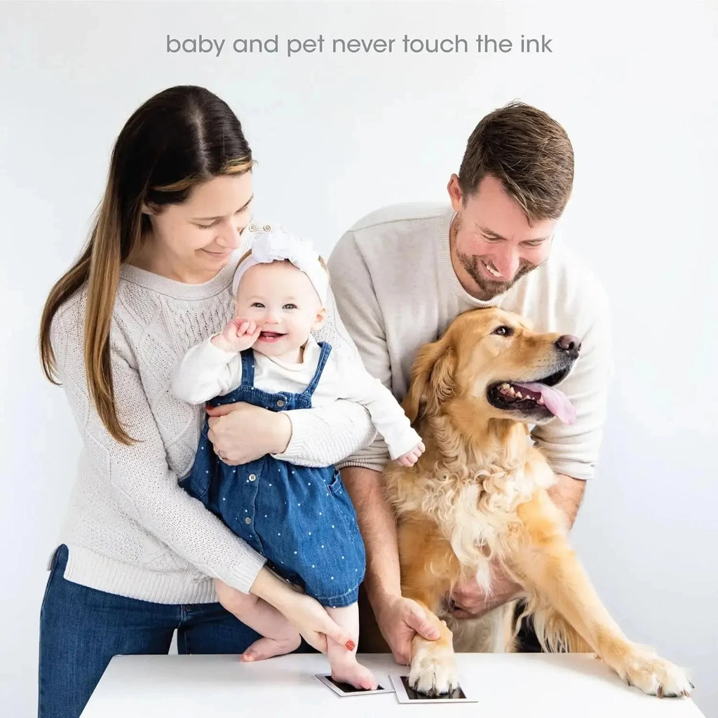 Family using mess-free inkless touch pad to create DIY dog paw and baby footprint keepsakes.