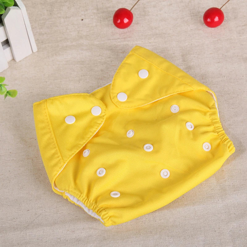 Yellow reusable cloth baby diaper with adjustable white snap buttons. Eco-friendly baby care essential.