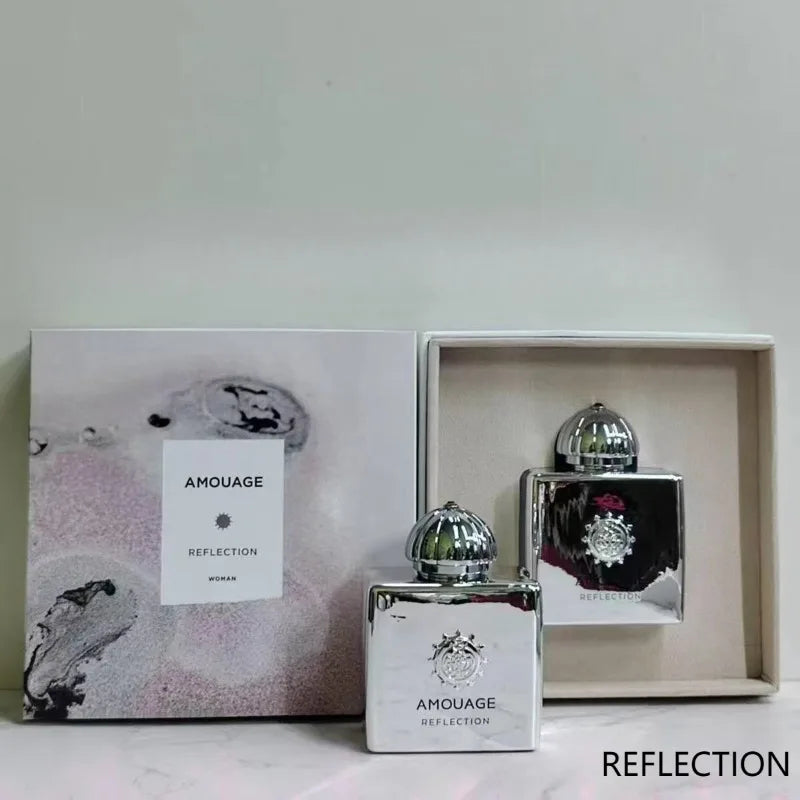 Amouage Reflection Woman EDP in a square, mirrored silver bottle with a dome cap. Luxurious floral, long-lasting scent.