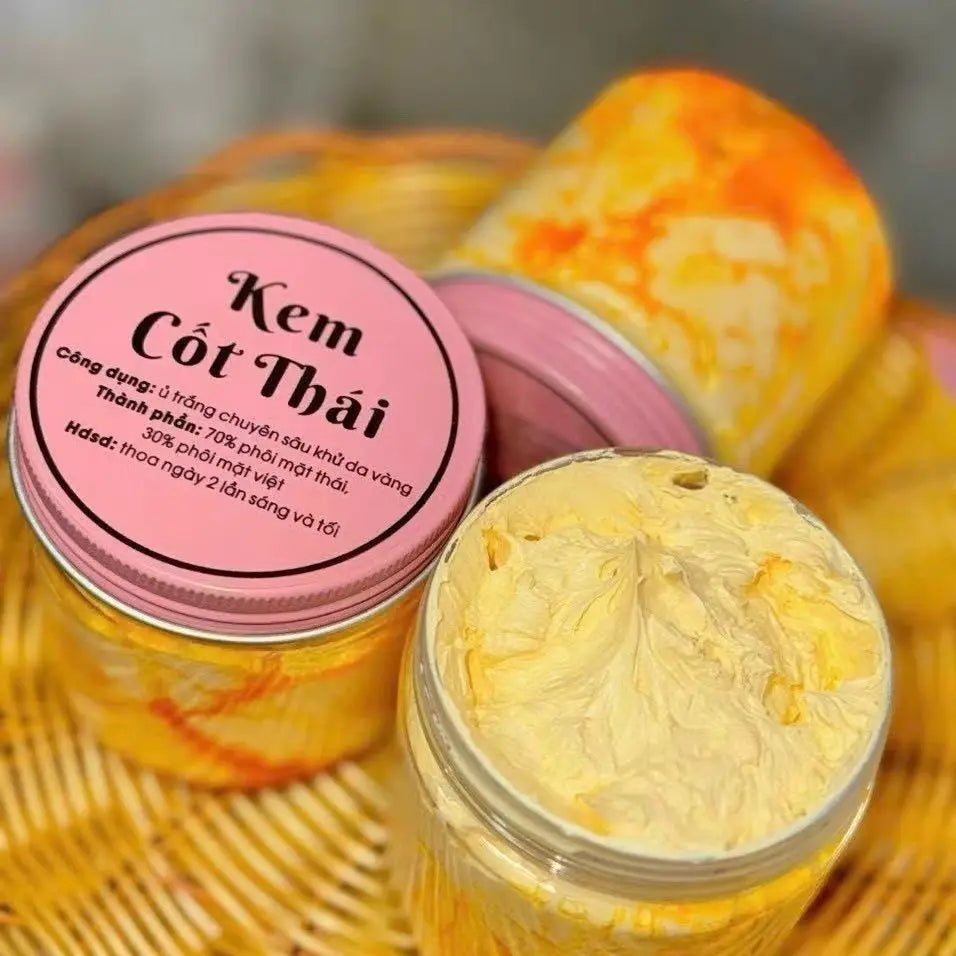 Kem Cốt Thái skin brightening cream in round jars with pink lids and thick yellow textured cream.