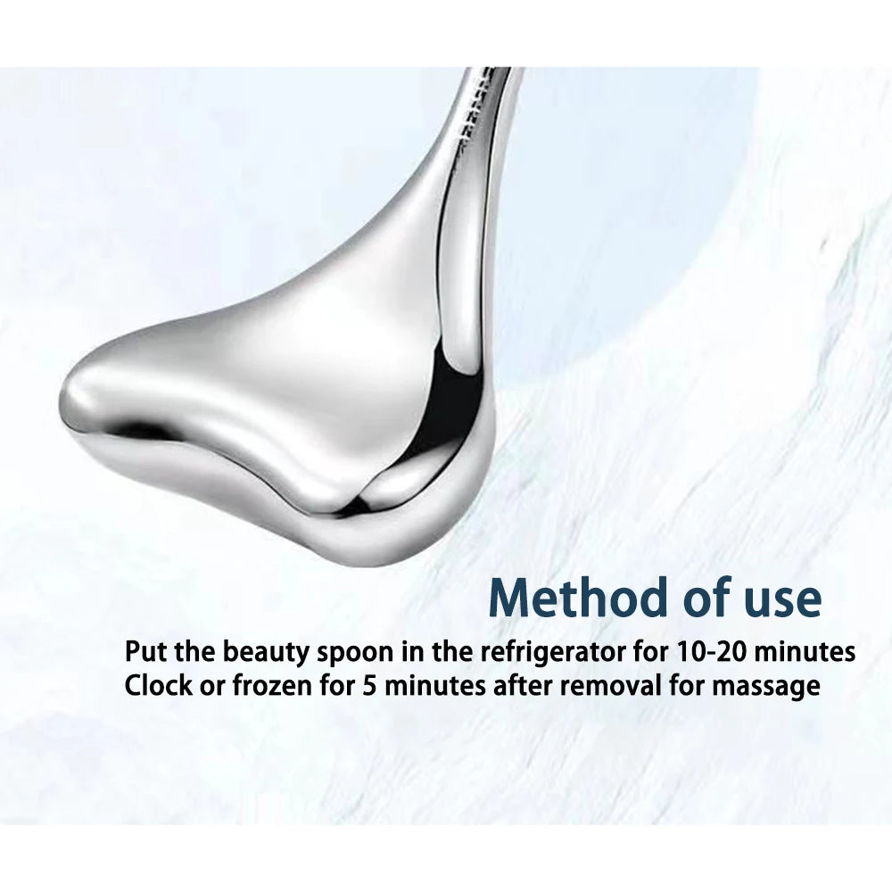 Close-up of a smooth, silver stainless steel Gua Sha cryo massage tool with curved, ergonomic edges.