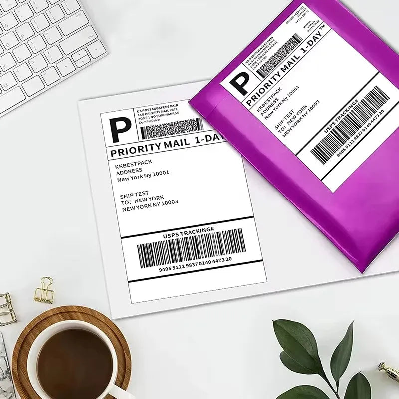 Priority mail thermal shipping labels on white envelopes with purple shipping pouch.