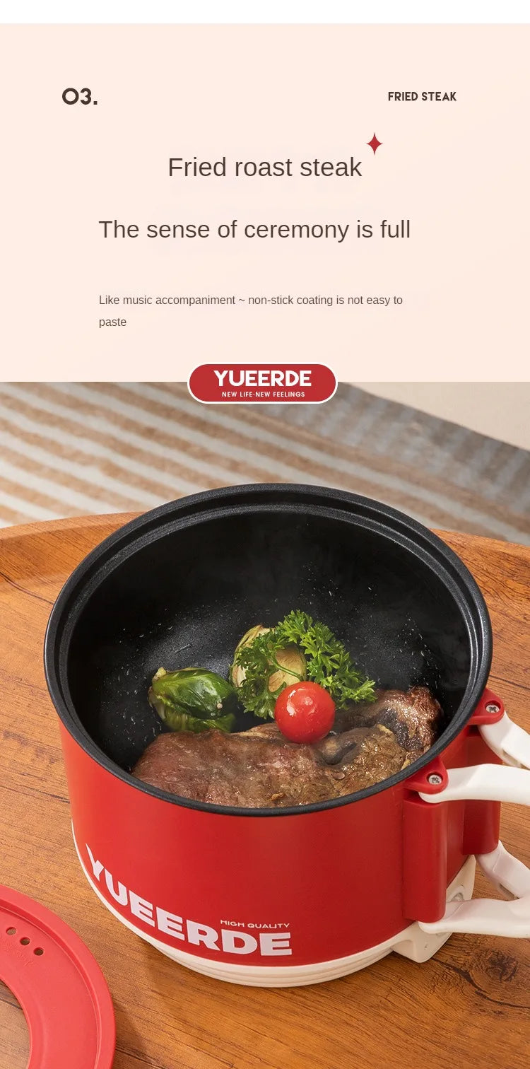 Red YUEERDE electric hot pot with fried steak and vegetables in the black nonstick pan