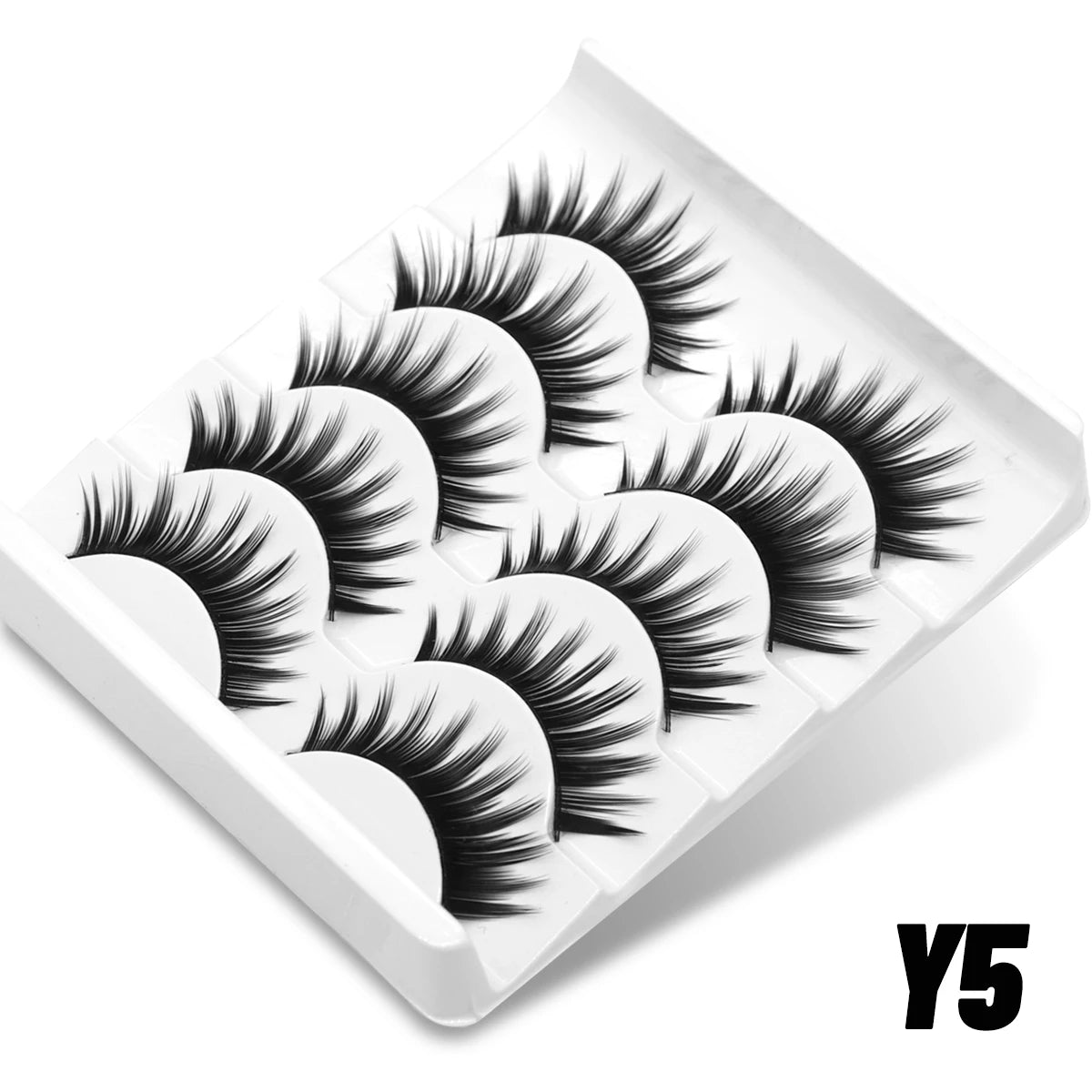 Five pairs of black, wispy 3D mink false lashes with a cat-eye shape, arranged in a white plastic storage tray.