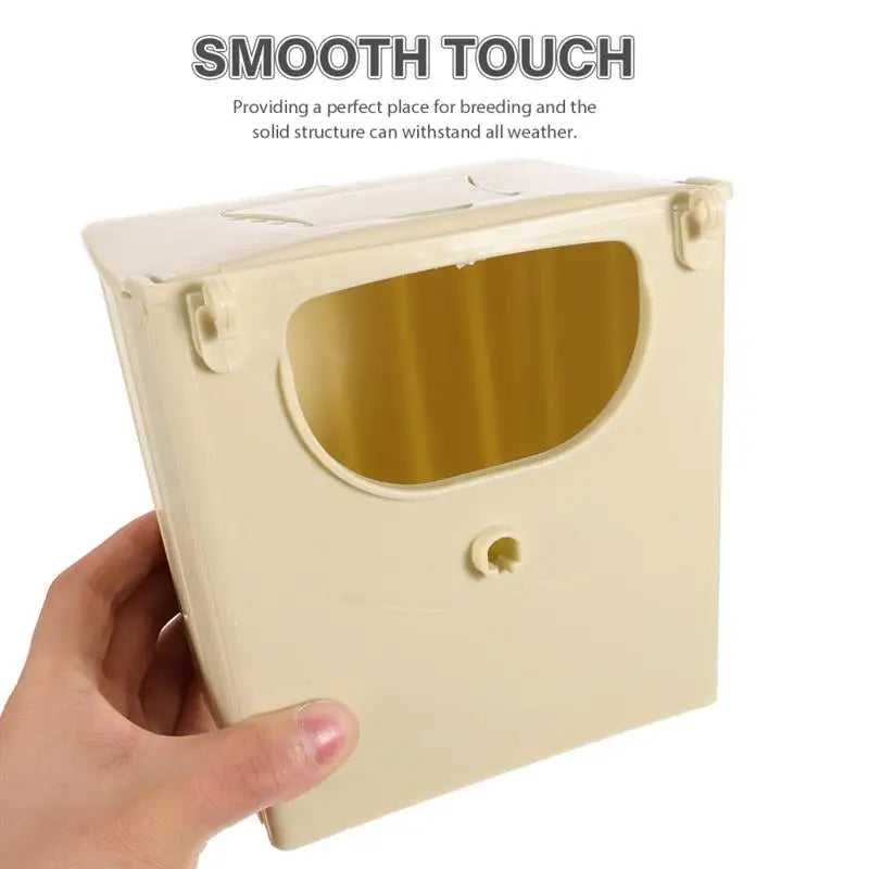 Beige plastic bird breeding nest box for lovebirds and parrots. Durable hanging incubation hut for cage or balcony.