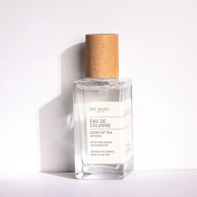 Shi Mang Scent of Tea woody green tea EDP for women, 50ml, minimalist glass bottle with rustic wood cap, long-lasting.
