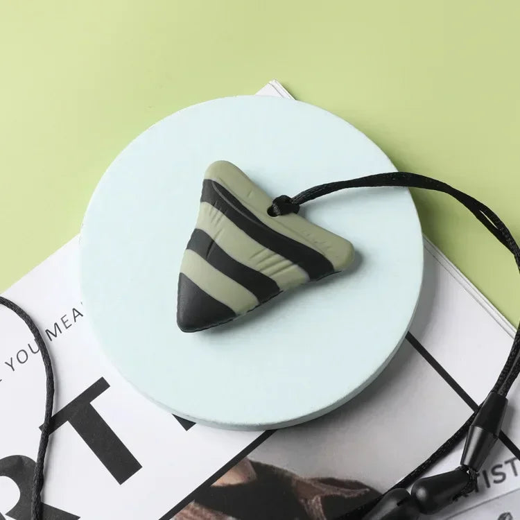 Green and black silicone baby teething toy pendant for soothing sore gums.