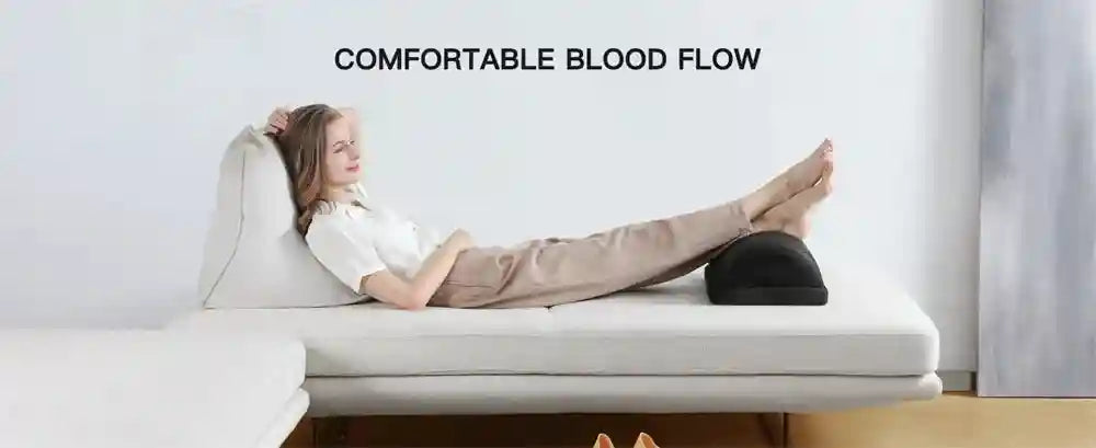 Black adjustable memory foam under desk foot rest cushion for leg and back pain relief during office work.