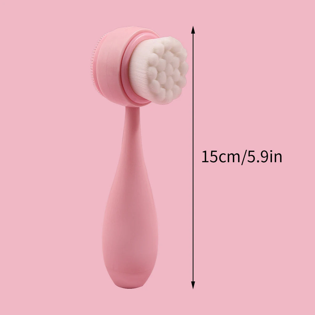 Pink handheld dual-sided manual facial cleansing brush with soft white bristles and silicone side for makeup removal.