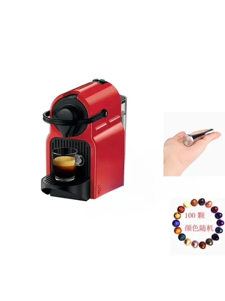 Red Nespresso coffee machine with small glass cup, metal tamper, and 100 assorted coffee capsules.