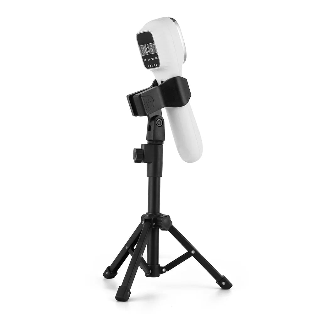 White handheld red light therapy device with a digital display, mounted on an adjustable black tripod stand.