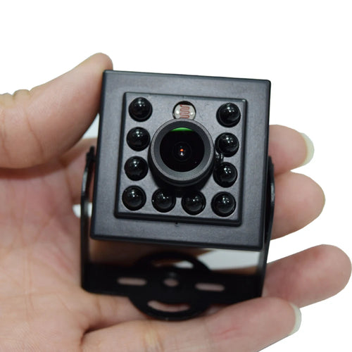 Mini square black security camera held in hands, showing IR LED array and lens