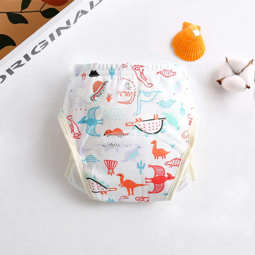 Baby care reusable cotton training diaper featuring colorful dinosaur print on white fabric.