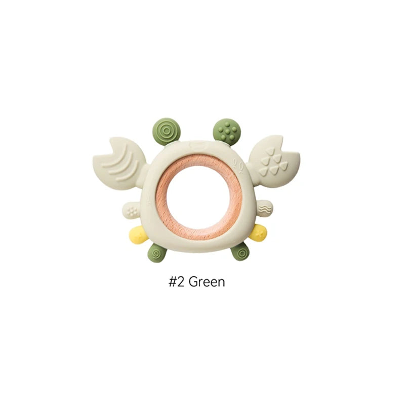 Green silicone and natural wood crab baby teething ring toy for infant teething relief.