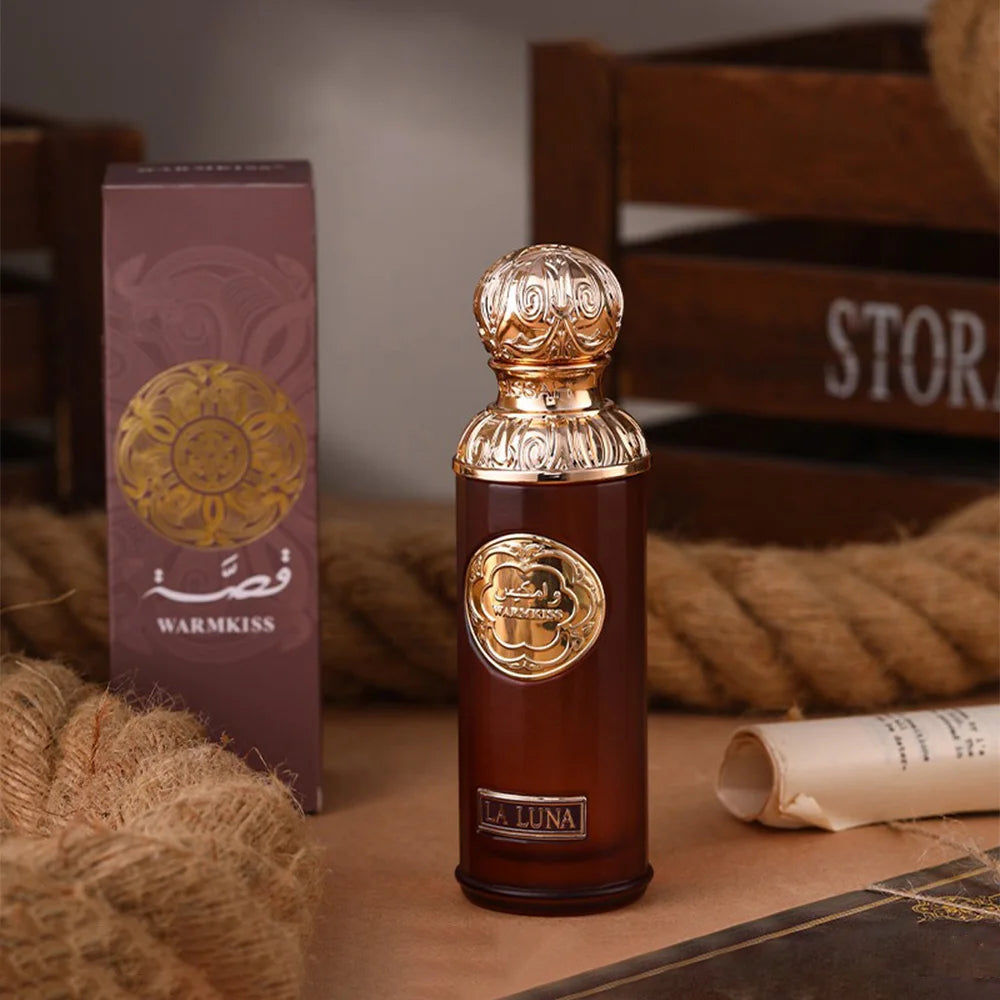 Warmkiss La Luna Arabian Oud EDP: Luxury unisex 100ml perfume in elegant brown bottle with ornate gold cap design.