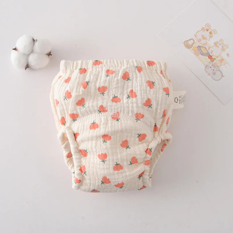 Size 80 baby training diaper with cute orange tulip print on soft muslin fabric for infant care.