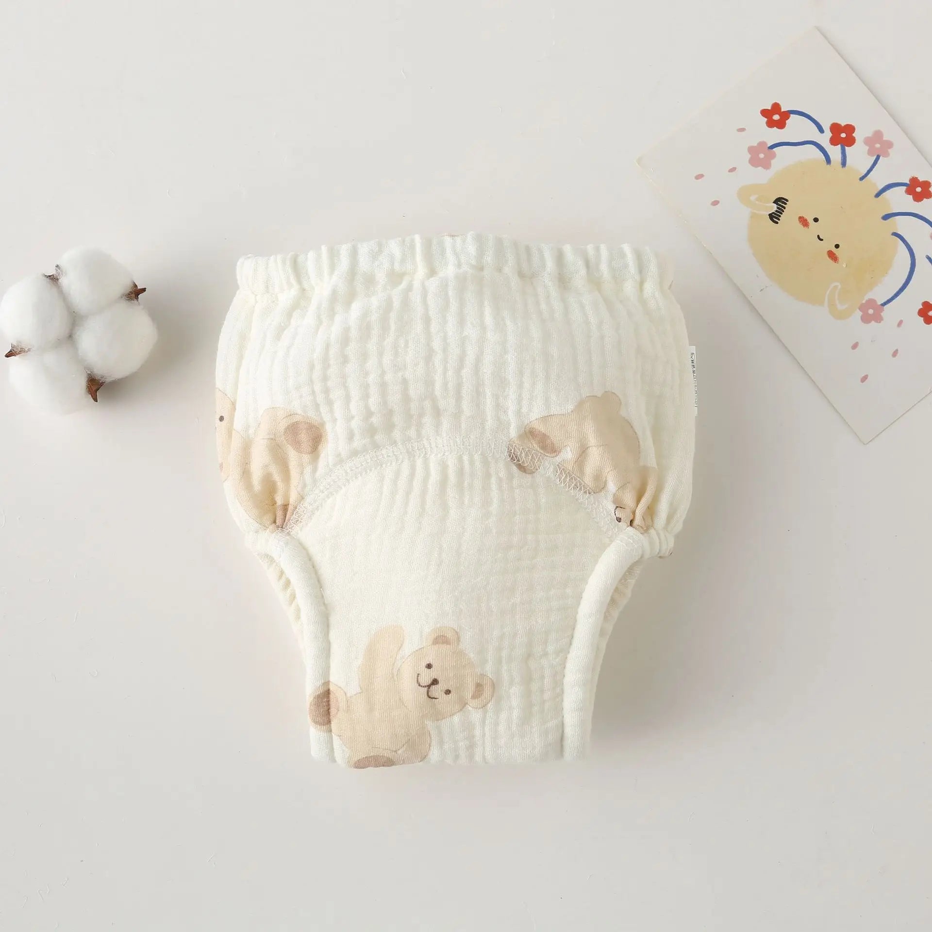 Soft cotton baby training diaper with cute teddy bear print, perfect for gentle baby care and comfort.
